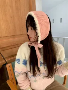 Warm pink knitted ear warmer with soft white plush trim and stylish tie-up straps.