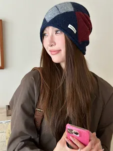 Close-up of a vintage argyle color-block knitted slouchy beanie worn by a female model