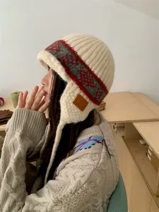 Detailed side view of a stylish retro jacquard knit earflap hat on a model