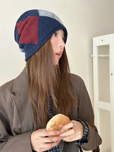 Asian woman wearing a vintage argyle knit slouchy beanie in a cozy lifestyle setting