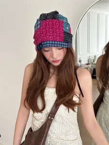 Detailed view of a colorful patchwork slouchy beanie headscarf worn by a female model