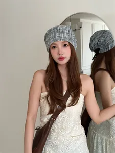 Fashionable blue plaid tie-up beanie hat for women shown on a model in a Korean style outfit