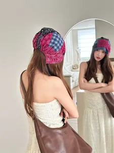 Detail showing the colorful patchwork pattern and tie-back design of the vintage beanie