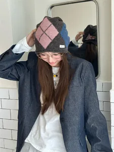 Detail view of a vintage argyle knit beanie with a cozy slouchy fit on a model.