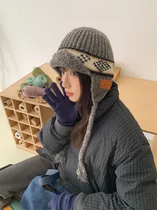 Detailed lifestyle view of vintage jacquard knitted trapper hat with warm earflaps