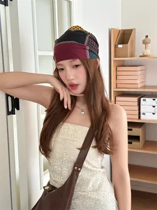 Detailed view of model wearing a stylish retro patchwork bandana headscarf indoors