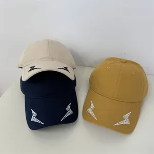 Three stylish embroidered lightning bolt baseball caps in beige, navy blue, and mustard yellow