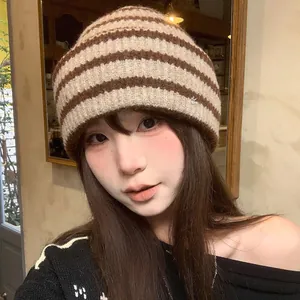 Young woman wearing a vintage brown and beige striped thick knit beanie for winter