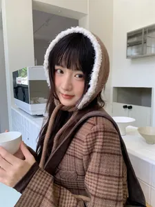 Close-up detail view of a soft brown plush knitted winter hood with tie-strap on an Asian model