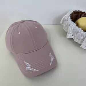 Fashionable dusty pink Korean baseball cap with white embroidered lightning bolt pattern.