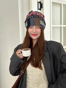 Close-up of a model wearing a vintage colorful patchwork beanie hat for women.