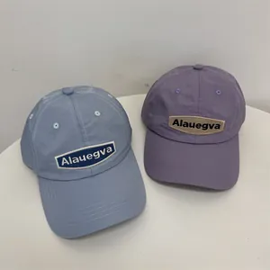 Lightweight quick-dry baseball caps in blue and purple with Alauegva patch