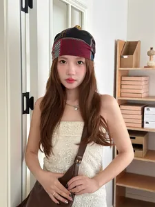 Vintage colorful patterned bandana beanie shown on a model in a natural lifestyle indoor setting