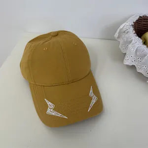 Mustard yellow baseball cap with two white embroidered lightning bolts on the brim.