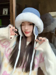 Detailed view of a woman wearing a plush winter ear-protection hat in blue and white