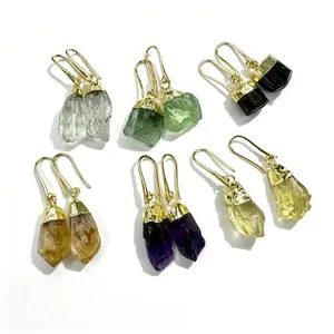 Detail of natural raw stone earrings including amethyst, citrine, fluorite and more