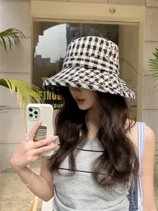 Fashionable women's checkered sun bucket hat featuring tiny hearts for sun protection
