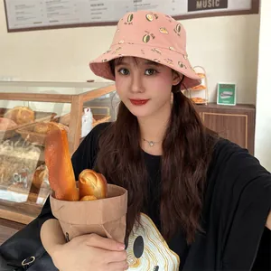 Lifestyle άποψη ενός ροζ καπέλου bucket με τύπωμα durian σε έναν όμορφο ζεστό φούρνο
