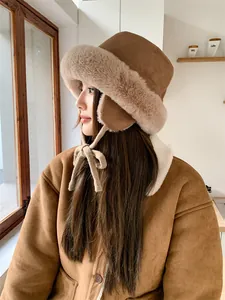 Side view of a warm brown plush bucket hat with ear flaps and soft faux fur trim