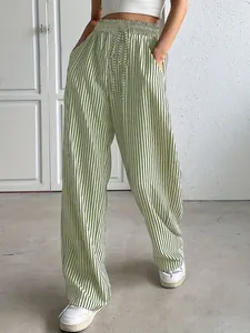 Detailed macro view of green and white striped wide-leg casual pants with drawstring waist