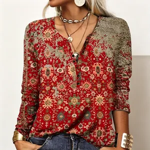 Close-up detail of the vintage ethnic floral print on a red V-neck long sleeve top