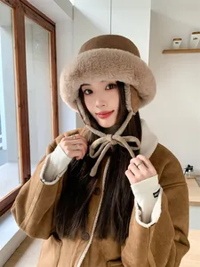 Detail view of a brown plush bucket hat with ear flaps and bow tie closure