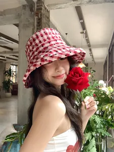 Stylish Asian model wearing a red and white heart plaid wide-brim sun protection bucket hat