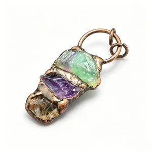 Detailed macro view of raw amethyst and green fluorite stones in antique copper pendant