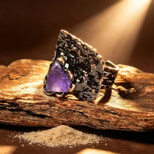Makrodetail eines rohen Amethyst-Edelsteins in einem verstellbaren Ring im Retrostil