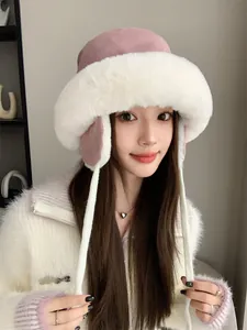 Close-up detail of a soft plush pink and white winter trapper hat with warm ear protection
