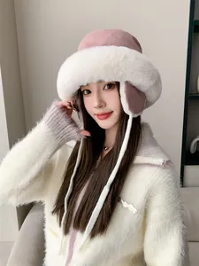 Detailed close-up of a stylish pink and white plush winter trapper hat with ear flaps.