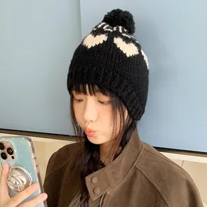 Retro black knit beanie with white heart pattern and pom-pom for women winter warmth