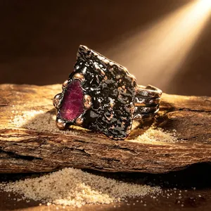 Detailaufnahme eines Vintage-Rings in Bronze-Optik mit einem rohen lila Edelstein