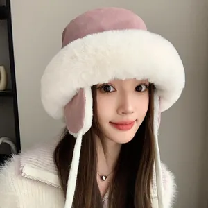 Warm and stylish winter plush bucket hat with faux fur trim and ear flaps in soft pink color