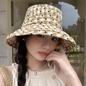 Stylish women's wide-brim bucket hat featuring a heart plaid pattern for sun protection
