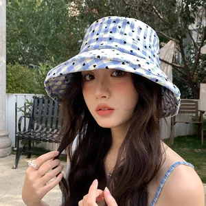 Stylish blue checkered bucket hat with small heart patterns for outdoor sun protection
