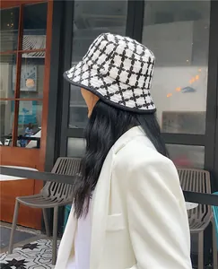 Stylish black and white checkered knit bucket hat for women, elegant winter fashion accessory