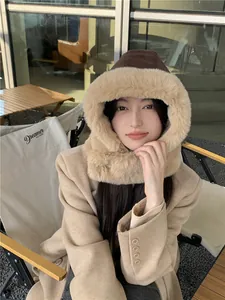 Woman wearing warm suede and faux fur trapper hat in outdoor camping setting