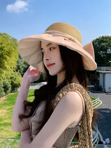 Detailed side view of a French vintage organza bow straw sun hat with elegant lace