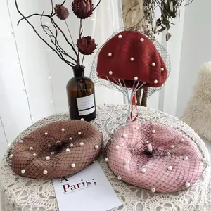 Detail of retro wool berets with pearl accents and mesh veils in various colors