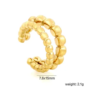 Detailed macro view of a golden stainless steel C-shaped beaded ear cuff earring
