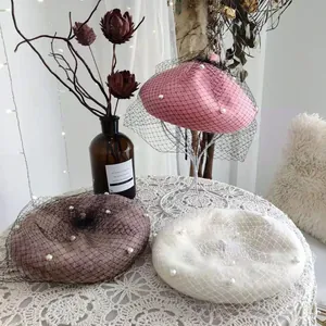 Elegant wool berets with delicate pearl accents and black mesh veil in three soft colors.