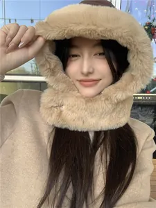 Close-up of a cozy camel plush hood hat with integrated scarf on a female model.
