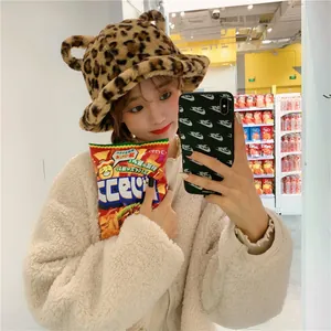 Detail shot of a sweet leopard print plush bucket hat featuring cute bear ears on top
