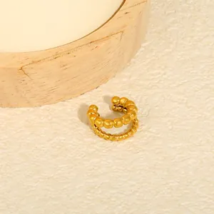 Detailed macro view of a gold-plated stainless steel beaded double-layer ear cuff.