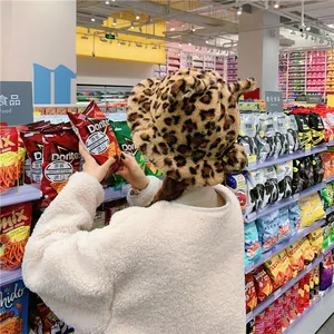 Stylish leopard print plush bucket hat for women in a vibrant supermarket scene
