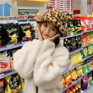 Cute leopard print plush bucket hat worn by a model in a trendy lifestyle setting