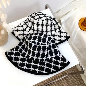 Stylish retro black and white plaid bucket hat with textured woven knit fabric pattern