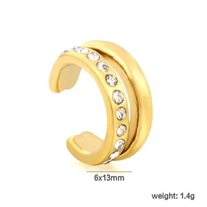 Detailed view of a golden stainless steel C-shaped ear cuff with sparkling inlaid crystals