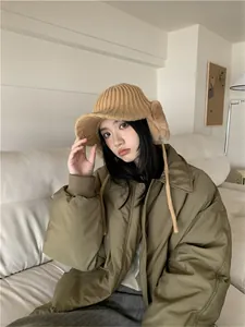 Fashionable women's winter warm knit earflap bucket hat shown on a model